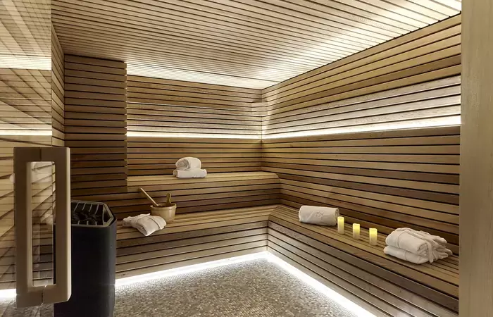 Wood-lined sauna with soft indirect lighting in the Lys Martagon spa, Courchevel 1850