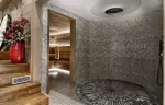 Round shower area with a mosaic floor in the Lys Martagon spa, Courchevel 1850