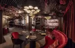 The red salon with banquette seating at Le Bottleneck, Le K2 Palace, Courchevel 1850