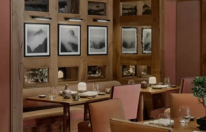 Laid tables and rust-coloured chairs in the Akari dining room