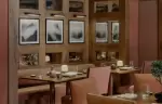 Laid tables and rust-coloured chairs in the Akari dining room