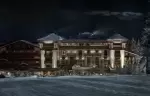 Aman Le Melezin after dark, every window of the facade lit