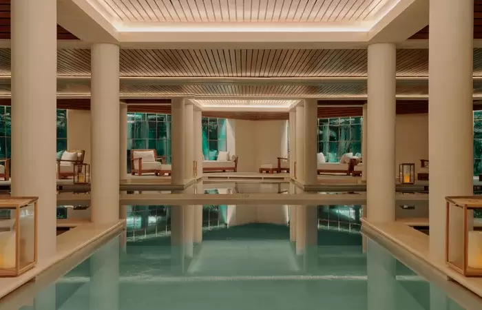Fourteen-metre indoor pool between stone columns at the Aman Spa