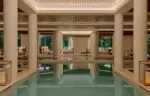 Fourteen-metre indoor pool between stone columns at the Aman Spa