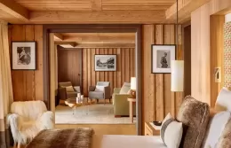 Elegant Deluxe Suite bedroom with access to a snowy terrac