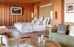 Bright Prestige Junior Suite interior with a large bed and stylish furniture.