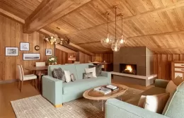 Cozy living room of the Prestige Suite with a fireplace and dining area.