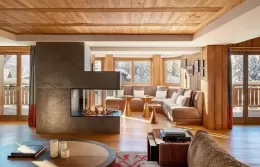 Penthouse living room with a modern fireplace and panoramic windows.