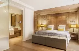 Bedroom with carved wood wall in a Junior Suite with Balcony, Hotel Mont-Blanc Chamonix
