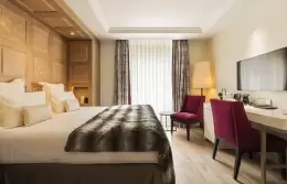 Standard Room with wood-panelled headboard wall, desk and red armchairs, Hotel Mont-Blanc Chamonix