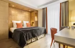 Superior Room with double bed, orange cushions and writing desk, Hotel Mont-Blanc Chamonix