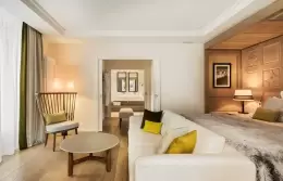 Junior Suite Mont-Blanc bedroom with orange cushions and bedside lamps, Hotel Mont-Blanc Chamonix