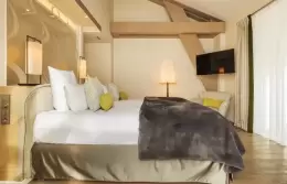 Duplex Suite bedroom with king-size bed and fur throw, Hotel Mont-Blanc Chamonix