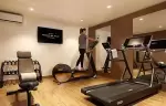 Fitness room with a treadmill, an elliptical trainer and dumbbells at Hotel Mont-Blanc Chamonix