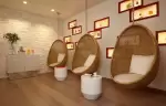 Relaxation room with hanging rattan egg chairs, Spa by Clarins at Hotel Mont-Blanc Chamonix