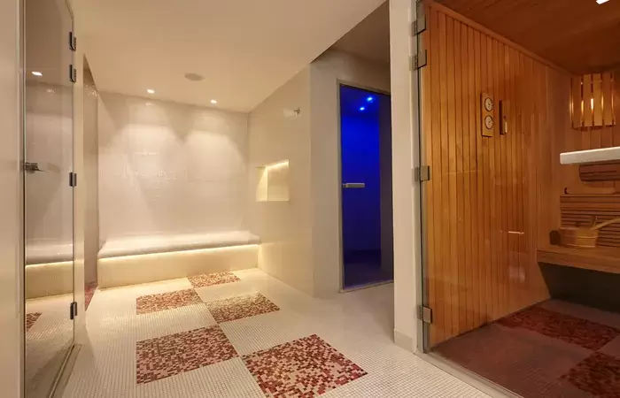 Spa area with mosaic floor and wooden sauna, Spa by Clarins at Hotel Mont-Blanc Chamonix