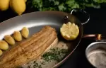 Fish with new potatoes served in a copper pan at L&rsquo;Altitude, Le K2 Altitude