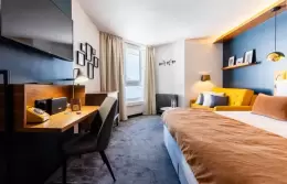 Desk area and double bed in a Double Room with slopes view, Fahrenheit Seven Val Thorens
