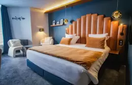 Desk area and double bed in a Double Room with slopes view, Fahrenheit Seven Val Thorens