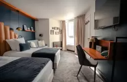Desk area and double bed in a Double Room with slopes view, Fahrenheit Seven Val Thorens