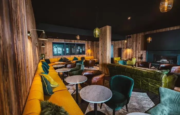 La Cheminee bar lounge with colourful sofas at Fahrenheit Seven Val Thorens