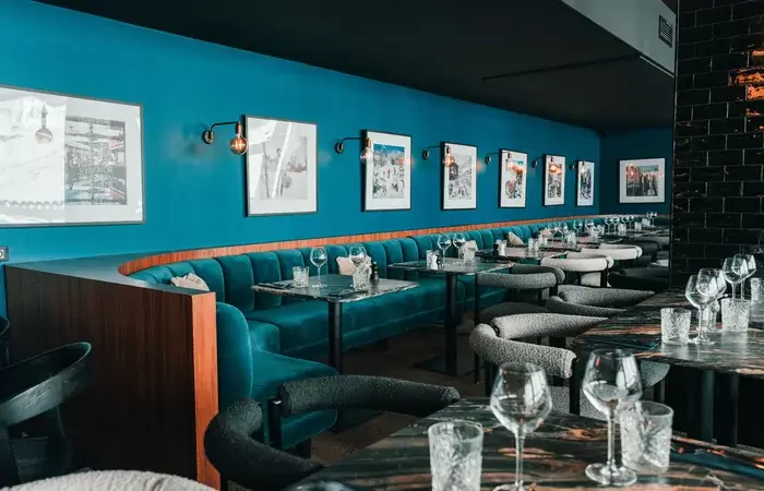 Dining room with banquettes and vintage ski photographs at Fahrenheit Seven Val Thorens