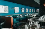 Dining room with banquettes and vintage ski photographs at Fahrenheit Seven Val Thorens
