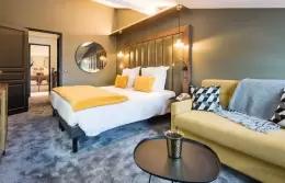 Bedroom with double bed and dormer window in the Duplex Top Floor Suite, Fahrenheit Seven Courchevel
