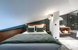 Black marble bathroom with bathtub and walk-in shower, Family Duplex Suite, Fahrenheit Seven Courchevel