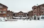 Wooden facade of Fahrenheit Seven Courchevel hotel under snow in Courchevel 1650 Moriond
