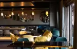 Dining tables and velvet armchairs at La Cheminee restaurant, Fahrenheit Seven Courchevel