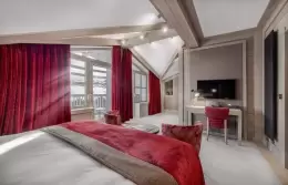 The bed by the window in a Premium Room at Le K2 Djola, Courchevel 1850