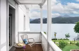 A Superior Room balcony with a chair overlooking Lake Lucerne, Chenot Palace Weggis