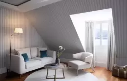 A Superior Room under a sloping ceiling with a sofa and armchair, Chenot Palace Weggis