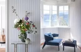 A bay window with an armchair and flowers, Panorama Lake View Classic, Chenot Palace Weggis