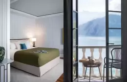 A bed and open balcony door facing the lake, Panorama Lake View Classic, Chenot Palace Weggis