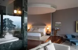 A Junior Suite bedroom beside a glass-walled marble bathroom at Chenot Palace Weggis