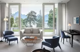 A Junior Suite sitting area with windows onto the lake and mountains, Chenot Palace Weggis