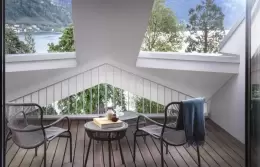 A roofed terrace with chairs and a glimpse of the lake, Executive Room, Chenot Palace Weggis