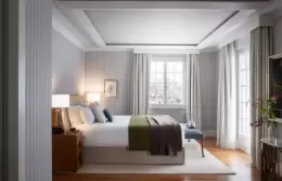 A Panorama Lake View Deluxe room with a double bed and tall windows, Chenot Palace Weggis