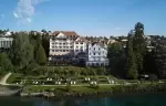 The hotel buildings and lakeside lawn seen from the water, Chenot Palace Weggis, Lake Lucerne