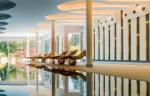 The indoor pool with wooden loungers and a sculpted ceiling, Chenot Palace Weggis