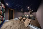 Cozy cinema room with starry sky ceiling at Chalet Orso in Val d-Isere.