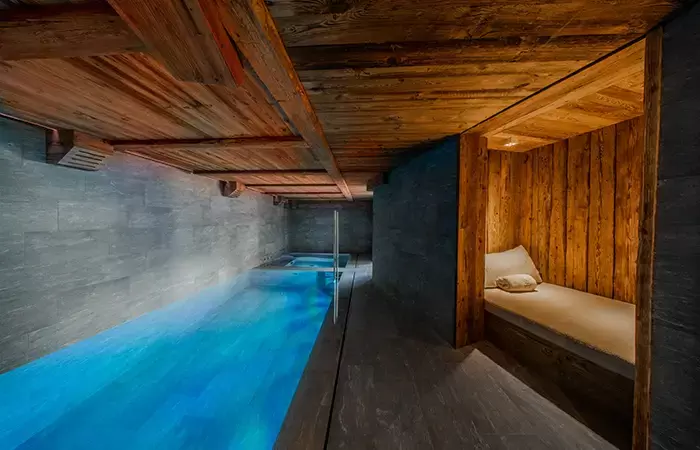 Indoor swimming pool and daybed relaxation area at Chalet Orso in Val d-Isere.