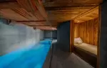 Indoor swimming pool and daybed relaxation area at Chalet Orso in Val d-Isere.