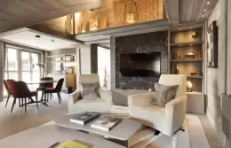 The living and dining room of an Exclusive Suite at Le K2 Chogori, Val d'Isere