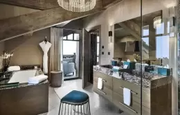 Deluxe Room 3 bedroom with a fireplace set below the television, Lys Martagon, Courchevel 1850