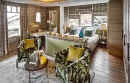 Deluxe Room 4 with leaf-print armchairs in front of the bed, Lys Martagon, Courchevel 1850