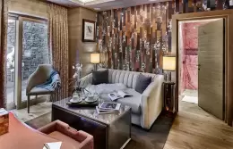 Deluxe Room 1 bedroom with glass doors onto a stone-walled terrace, Lys Martagon, Courchevel 1850