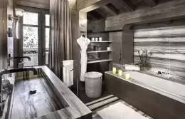 Deluxe Room 2 bed with a padded headboard and a grey throw, Lys Martagon, Courchevel 1850